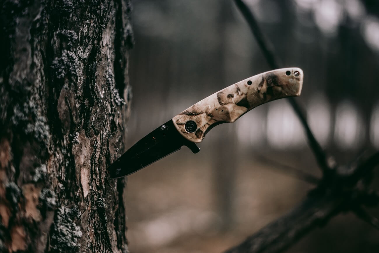 One of the best neck knives stuck in a tree